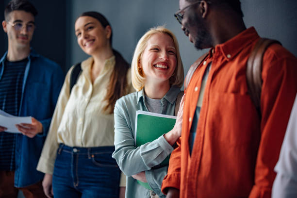 istock Group of Students Standing and Talking to Each Other while Holding Notes 1408304083