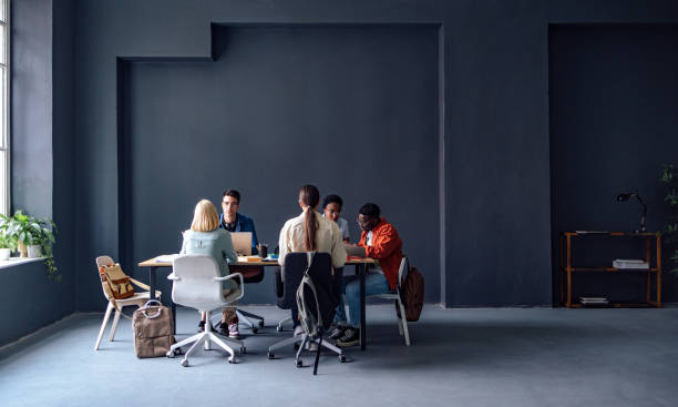 istock Group of Students Sitting at the Table Learning Together at University 1408304095
