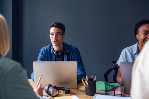 istock Portrait of a Male Student Using His Laptop While Learning With Friends 1408304100