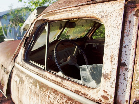 Rusted classic car on the roadside