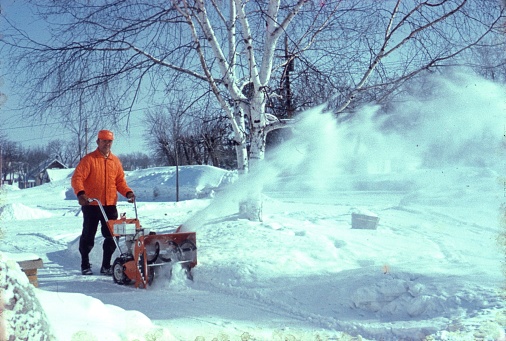 Pennsylvania (exact location unknown), USA, 1971. A man clearing snow with a snow plow machine