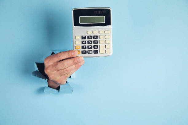 istock A man hand holds a calculator on blue background 1408306060