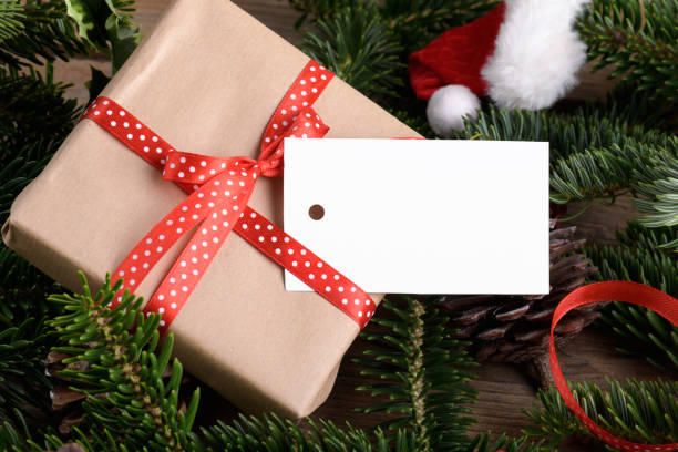 istock Christmas rectangle gift tag mockup with present box, product label mockup, with natural fir tree branch, name tag 1408308912
