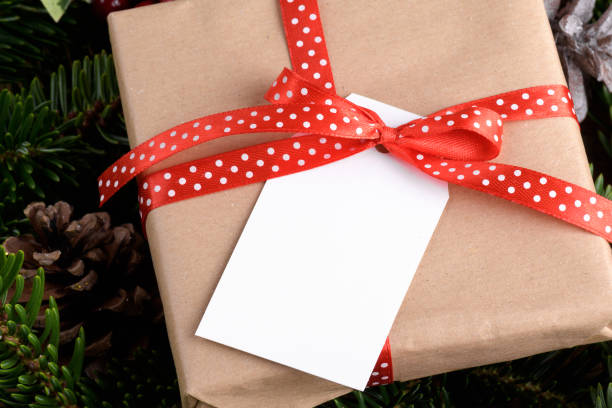 istock Christmas rectangle gift tag mockup with present box, product label mockup, with natural fir tree branch, name tag 1408308913