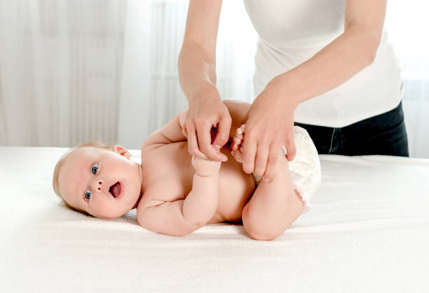 istock Mother massaging her infant baby 1408310145