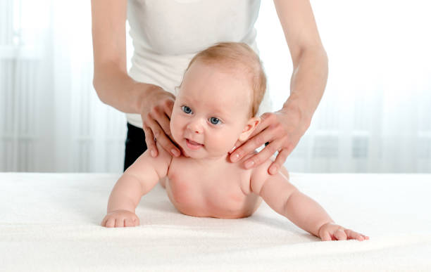 istock Mother holding and playing with newborn at home 1408310174