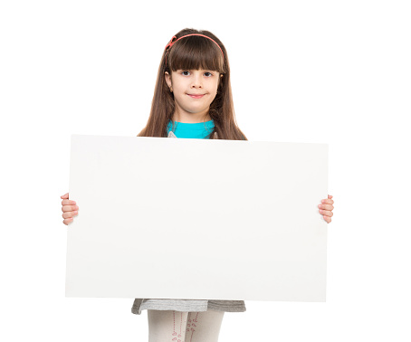 cute little girl with empty paper sheet in hands isolated on white background