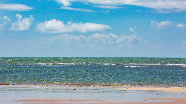 istock beach with clear water and clouds coming 1408313570