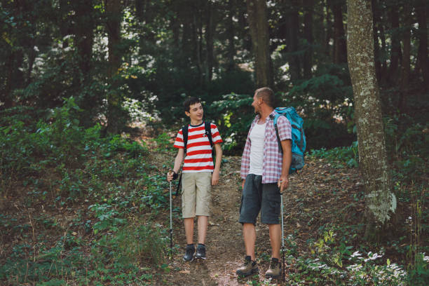 istock Father and son hiking together. 1408314941