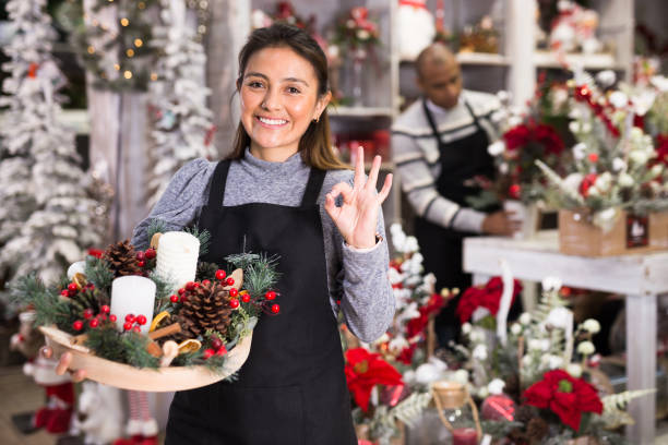 istock Flower shop worker making christmas compositions 1408316209