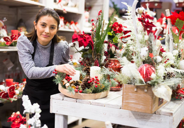 istock Flower shop worker making christmas compositions 1408316268