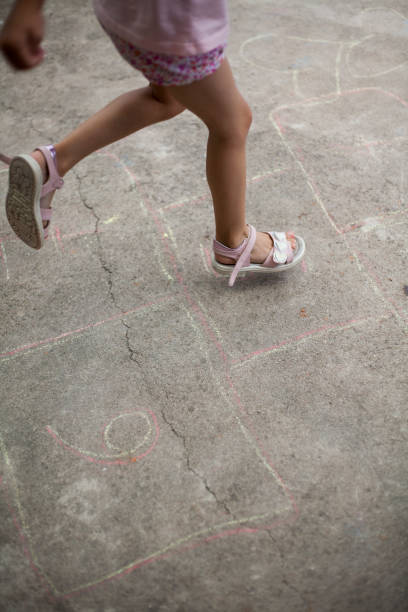 istock girl playing hopscotch 1408317549