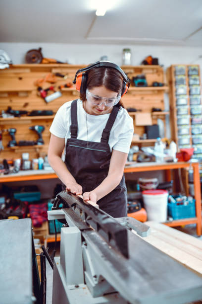 istock Expert Female Carpenter Sanding Cut Planks For Woodwork In Workshop 1408317785