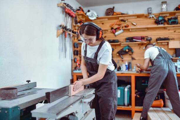 istock Male And Female Carpenters Utilizing Teamwork In Workshop 1408317846