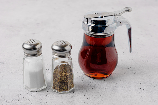 Balsamic vinegar, salt, and black pepper close up