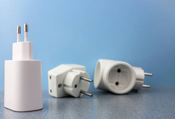 istock Electrical adapters for sockets. Adapters for different types of electrical sockets. Plug adapters on a blue background. 1408321978