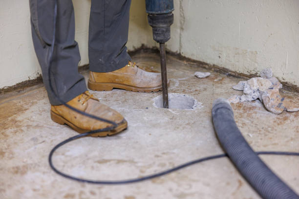 istock A worker is making a hole in the basement floor to install a radon mitigation system, using a drill bit. 1408328848