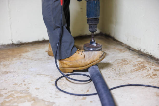 istock A construction worker is drilling a well in the basement floor with a hollow drill shank for home improvement. 1408328854