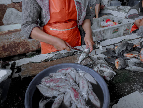 istock A fish seller is cleaning his selling fish 1408328909