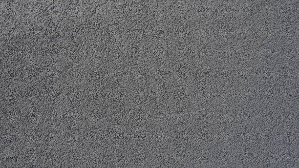 istock Gray background. Neatly plastered gray or black wall. Rough texture. Velvety effect. Professional finishing of walls, interiors, facades of buildings and premises. Construction and design. 1408329704