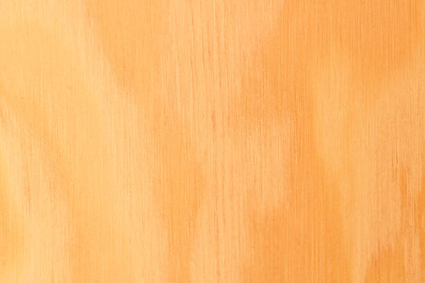 Close-up of mahogany wood surface featuring rich reddish-brown coloration and vertical grain patterns. The smooth finish and natural texture highlight the elegance and depth of this premium hardwood, ideal for luxury furniture, cabinetry, flooring, and interior design accents. Perfect for showcasing timeless craftsmanship and organic warmth.