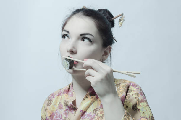 istock Asian woman with sushi 1408334657