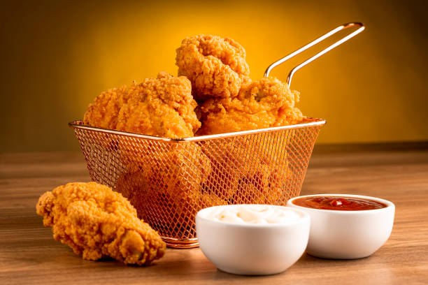 Crispy fried chicken in the basket. Crispy fried chicken in the basket. nuggets heat stock pictures, royalty-free photos & images
