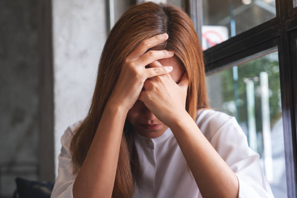 istock A young woman with feeling sad and stressed, sick and headache 1408344254