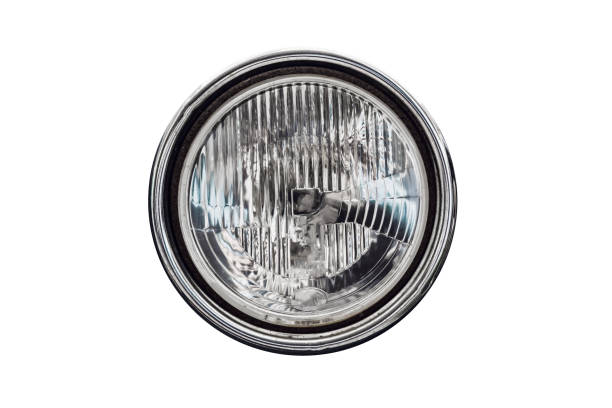 Old round headlight, an old-timer vehicle detail isolated on white background, close up