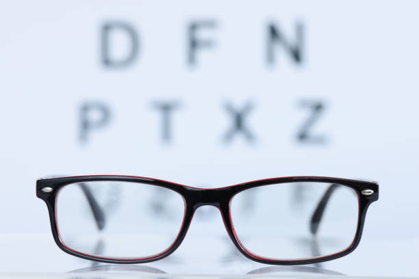 istock Glasses in black frame lying on background of eye test table closeup 1408348467