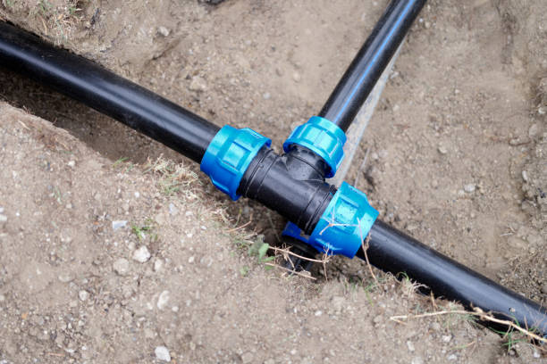 istock Equipment for automatic watering soil pipes lying in ground closeup 1408348514