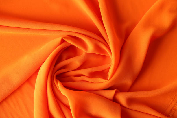 Orange texture of cotton or synthetic fabric. Fabric background