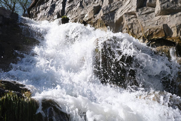 Beautiful fast mountain waterfall with foamy water. Natural scenery concept