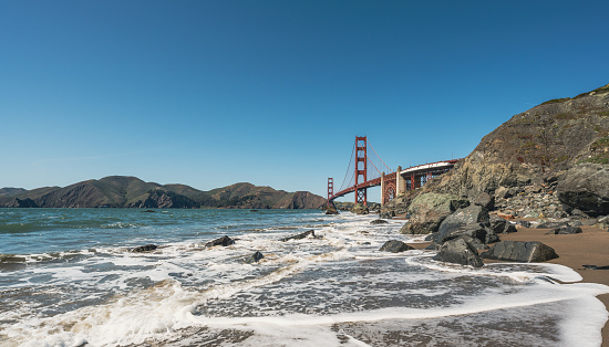 The Golden Gate Bridge in San Francisco seen a sunny morning from the beach in California, USA.