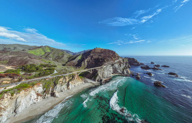 Big sur coastline The pacific highway one crossing an old bridge at the Big Sur coastline in California, USA. rocky coastline stock pictures, royalty-free photos & images