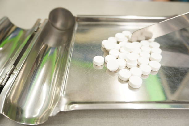 istock White pill on the pill counting tray , background , close up, background. 1408352116