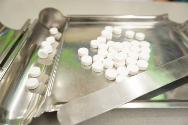 istock White pill on the pill counting tray , background , close up, background. 1408352132