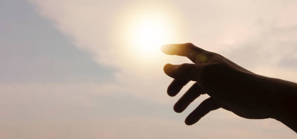 istock Hands reaching out to bright sky with copy space for ideas or text. 1408355483