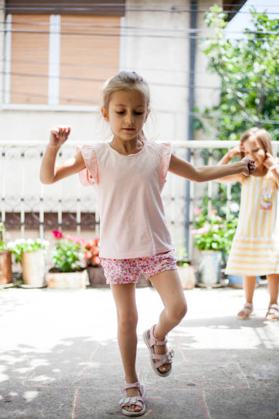 istock girls playing hopscotch 1408355603