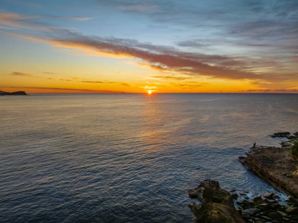 istock Sunrise over the sea with high cloud 1408363106
