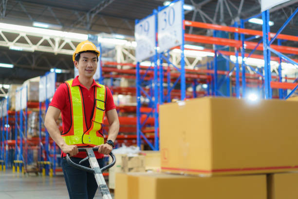 istock Shipping boxes. Asian man Warehouse worker unloading pallet shipment goods into a truck container, warehouse industry freight, logistics and transport. 1408363829
