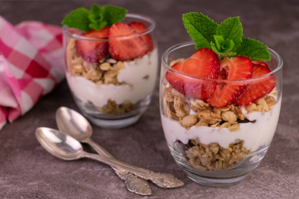 istock Two strawberry desserts with yogurt and granola. 1408364012