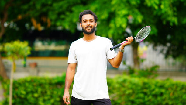 istock young man playing badminton image hd at outdoor shoot 1408368104