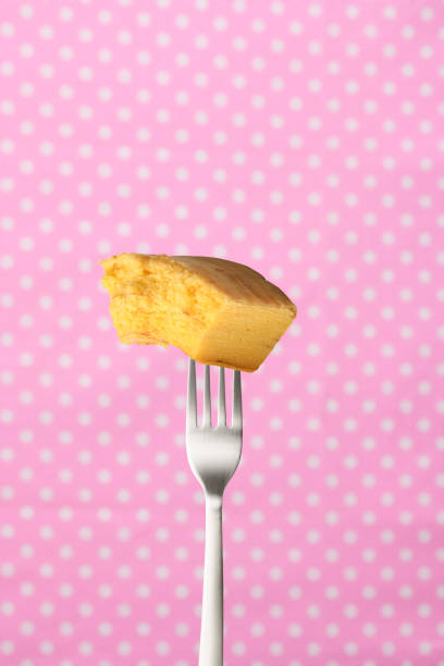 istock Fork and chewed baumkuchen against a pink polka-dot tablecloth 1408371237