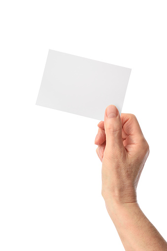 Close-up of a hand holding a blank paper on white background.