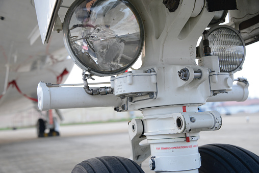 Close-up shot of a corporate private jet's landing gear with suspension. See other images in the collection for shots of chocks, wheel system and runway.