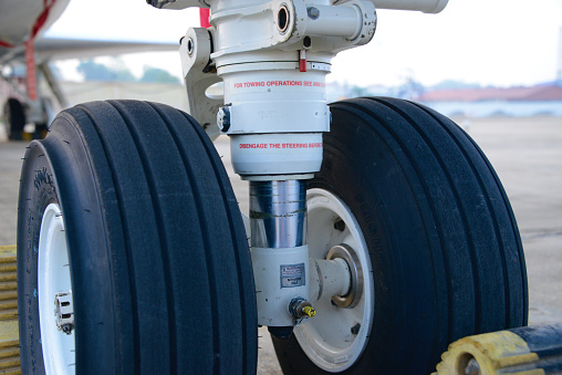 Close-up shot of a corporate private jet's landing gear with suspension. See other images in the collection for shots of chocks, wheel system and runway.