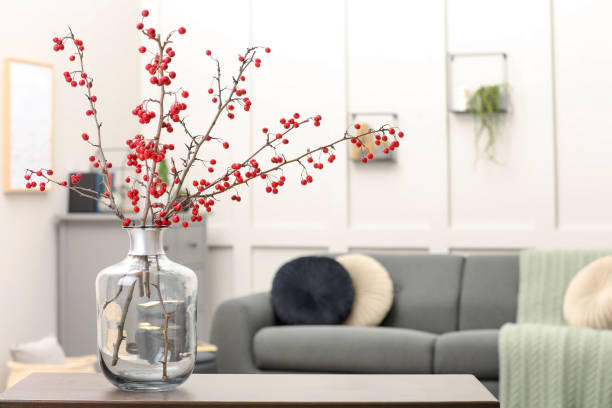 istock Hawthorn branches with red berries on table in living room, space for text 1408371899