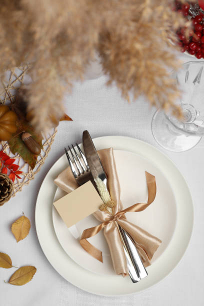 istock Beautiful autumn place setting with blank card and decor for festive dinner on table, flat lay 1408372061