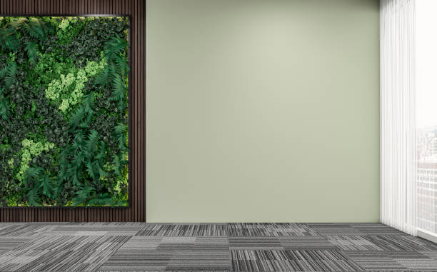 istock Empty unfurnished office interior with a vertical garden, partly hardwood background, partly light green plaster wall, and large windows 1408372669